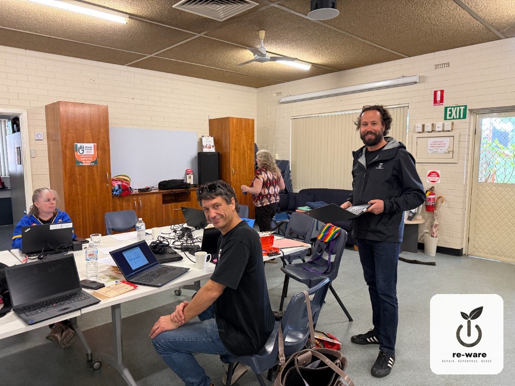 Re-Ware handing over a refurbished laptop at Grandcarers WA