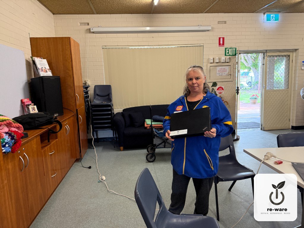 A Grandcarers WA recipient holding a refurbished Re-Ware laptop